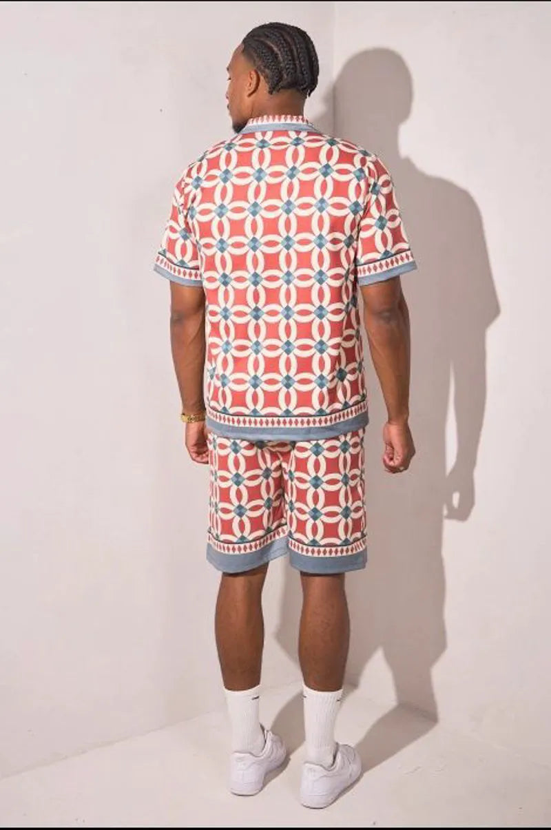 Two-piece ensemble in gray and red with geometric pattern shirt and shorts.
