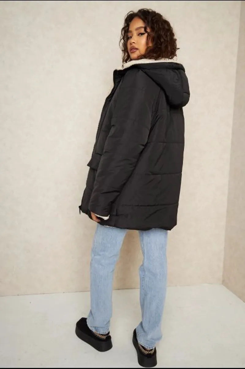 Reversible black down jacket with faux fur-lined hood