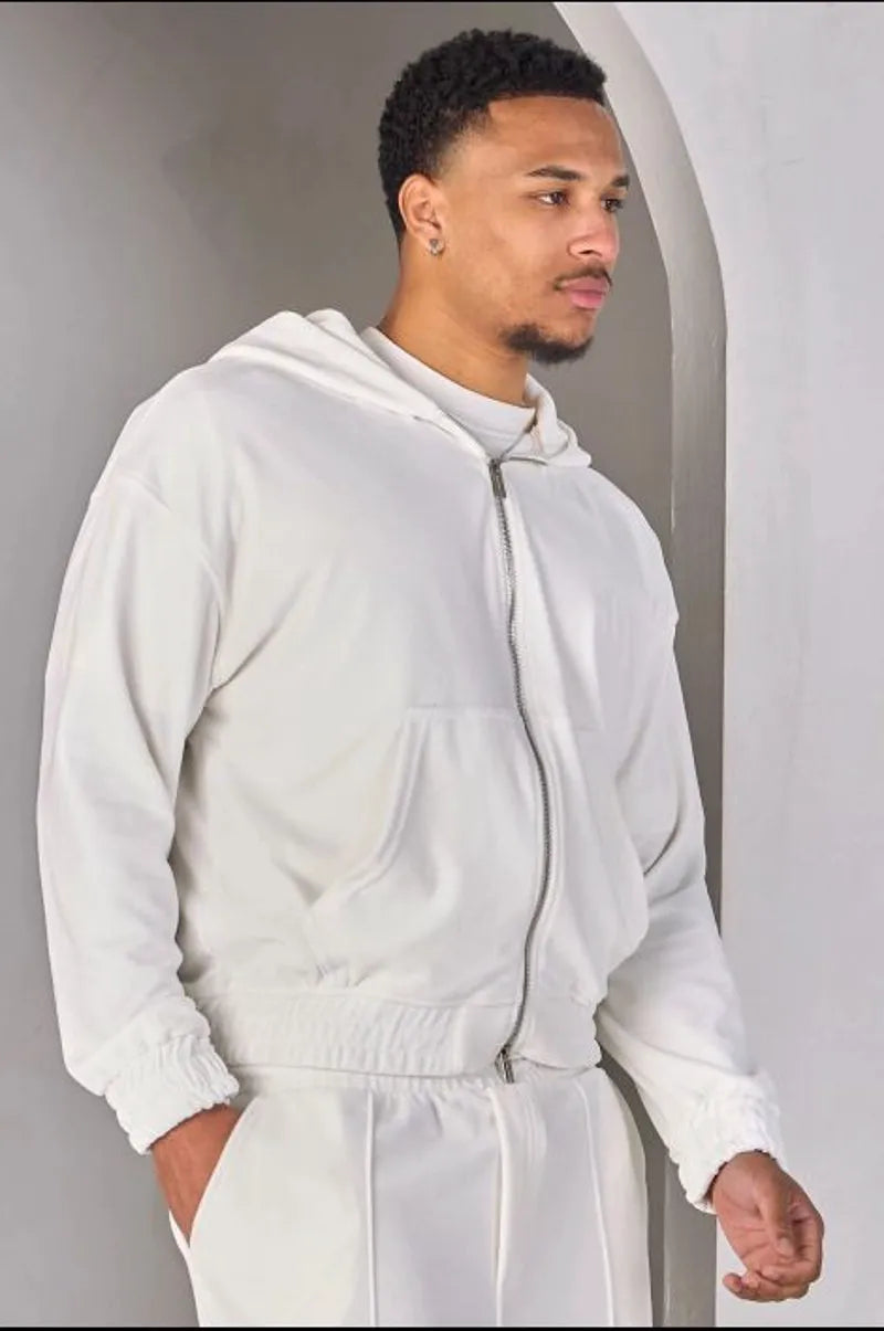 Two-piece ensemble: white velvet zip-up sweatshirt and joggers.