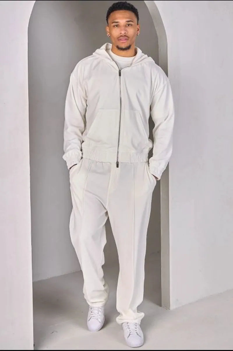 Two-piece ensemble: white velvet zip-up sweatshirt and joggers.