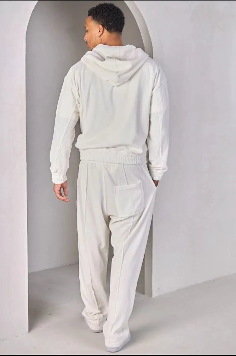 Two-piece ensemble: white velvet zip-up sweatshirt and joggers.