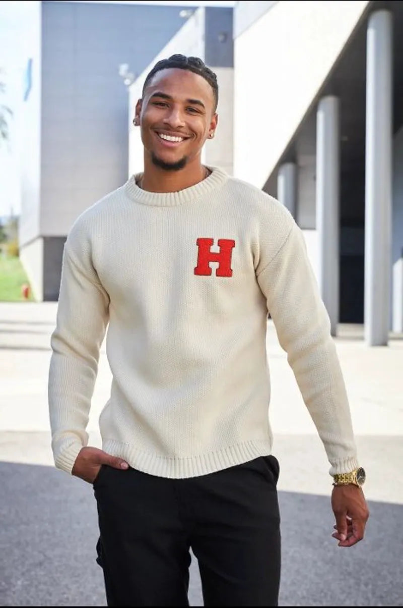 Beige knit sweater with orange "h" logo