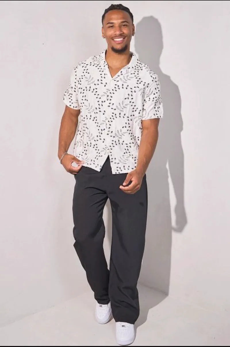 Beige linen shirt embroidered with blue leaves