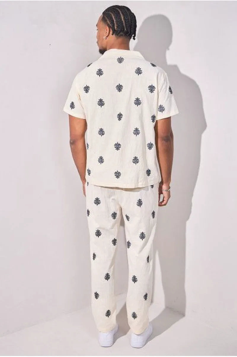 Two-piece ensemble with embroidered linen-effect shirt and beige trousers