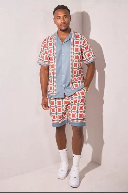 Two-piece ensemble in gray and red with geometric pattern shirt and shorts.