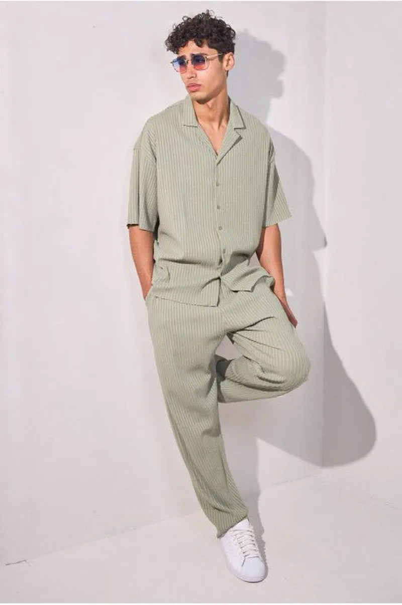 Two-piece ensemble in khaki with striped dual-texture shirt and trousers.