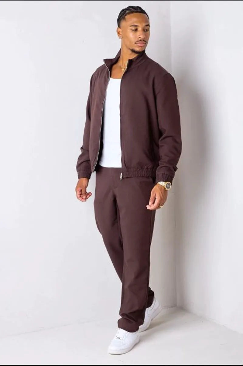 Brown two-piece ensemble with zip-up jacket and trousers.