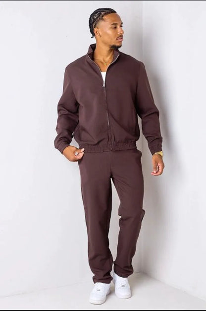Brown two-piece ensemble with zip-up jacket and trousers.