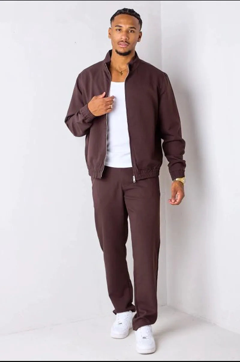 Brown two-piece ensemble with zip-up jacket and trousers.