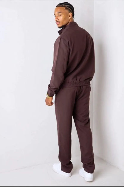 Brown two-piece ensemble with zip-up jacket and trousers.
