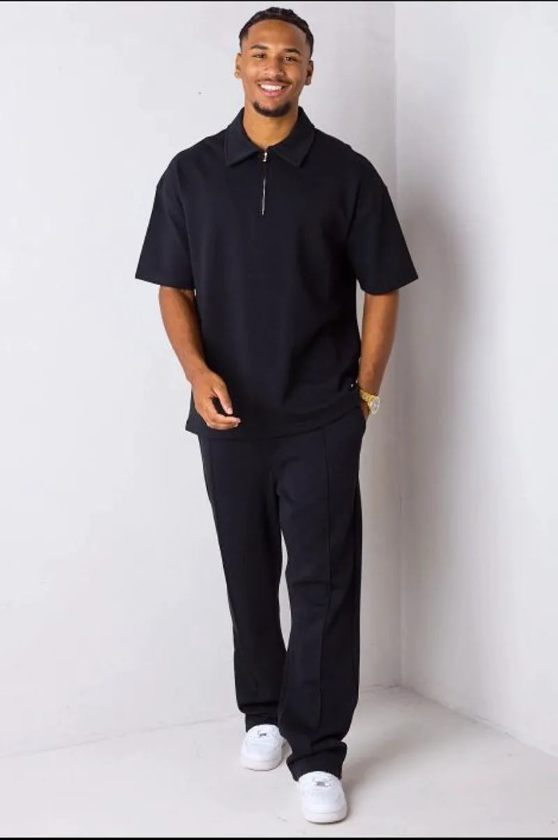 Two-piece ensemble: black zip-up polo + straight-leg trousers