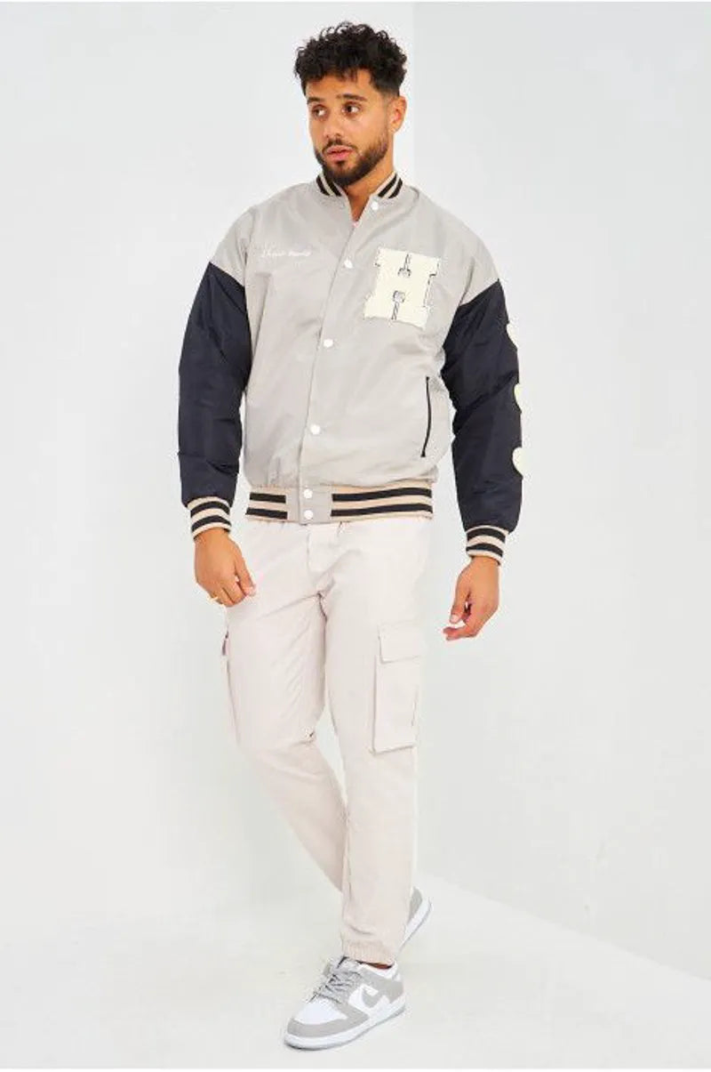 Gray bomber jacket with black sleeves embroidered with "parisian brand"