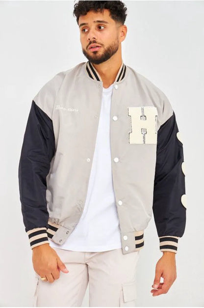 Gray bomber jacket with black sleeves embroidered with "parisian brand"