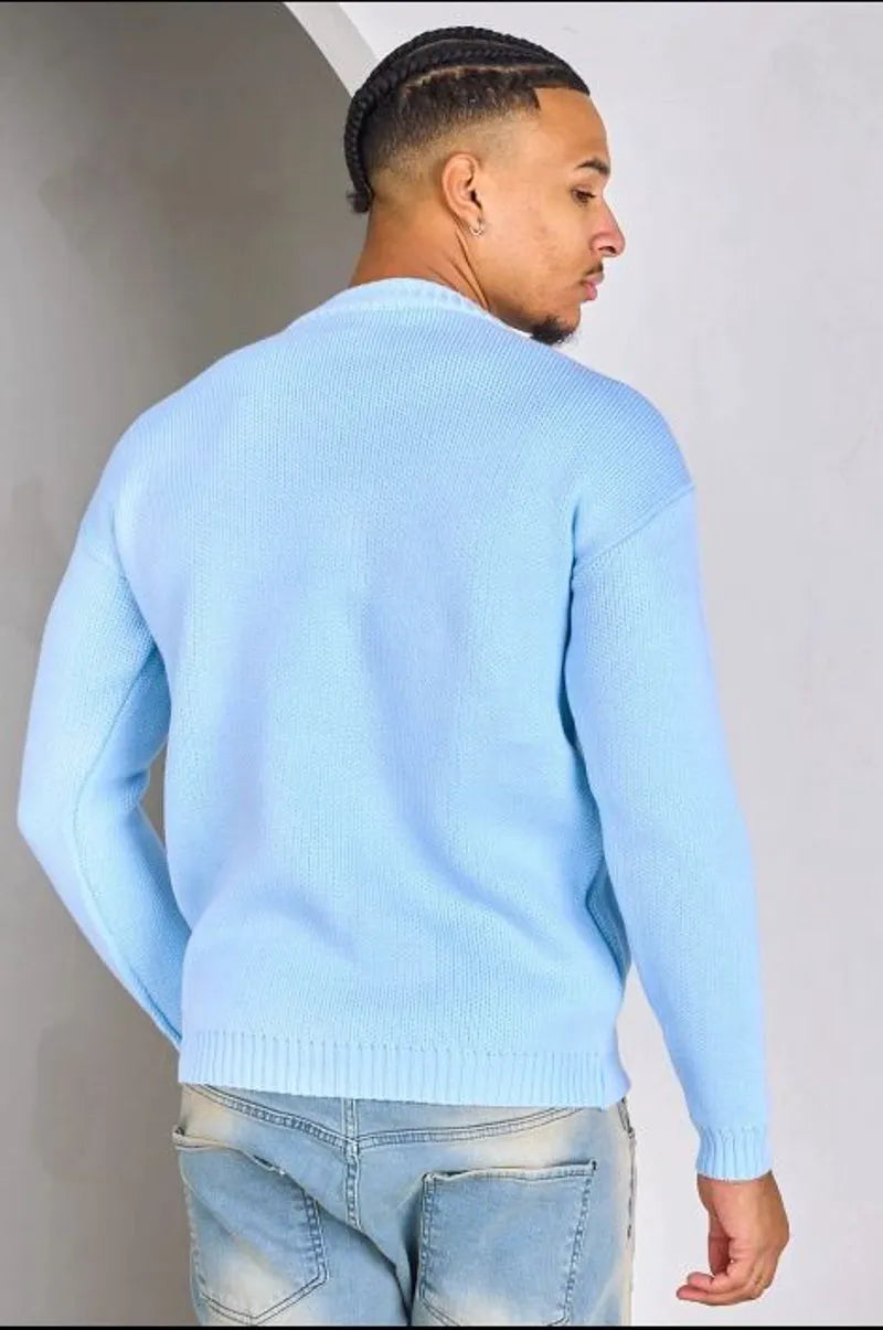 Light blue knitted sweater with "c" logo