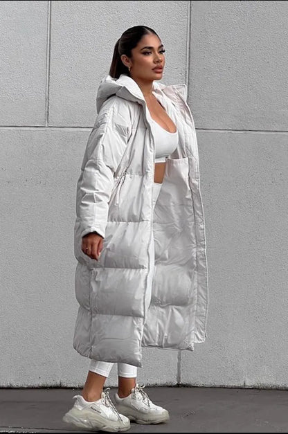 Long beige quilted down coat with double zipper closure