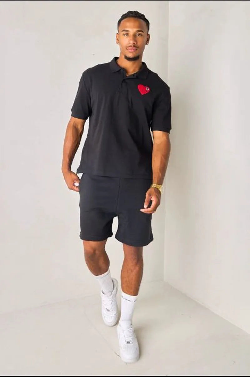 Black polo with heart appliqué