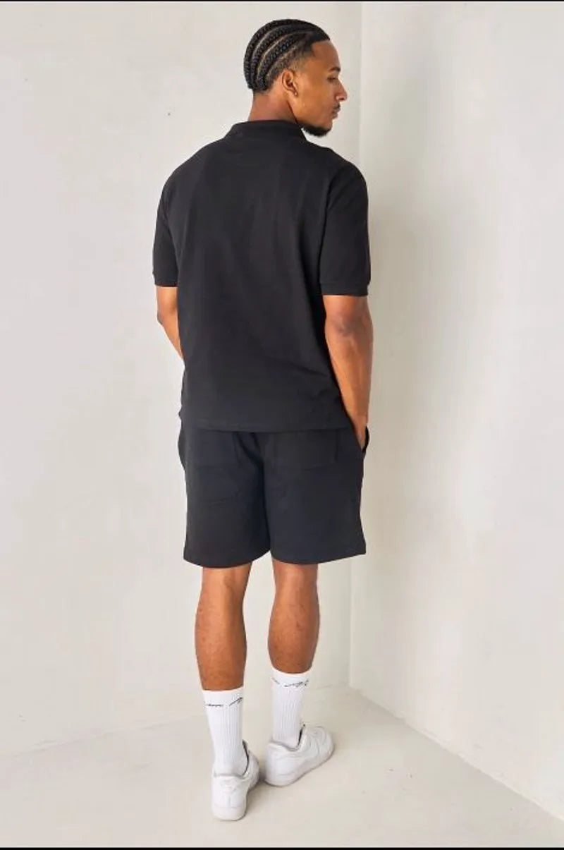 Black polo with heart appliqué