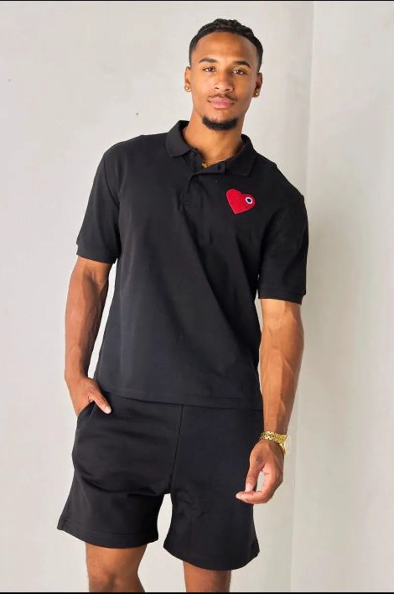 Black polo with heart appliqué