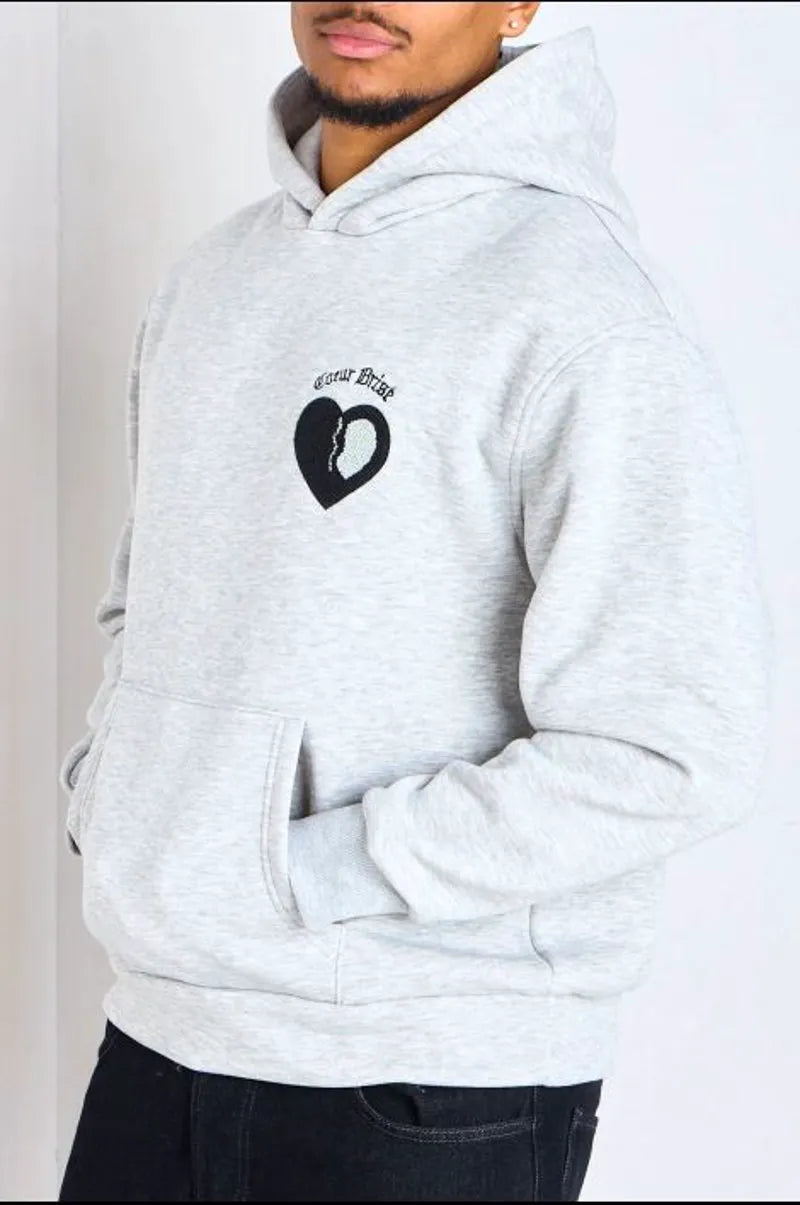 Light gray hooded sweatshirt with long sleeves and inscription