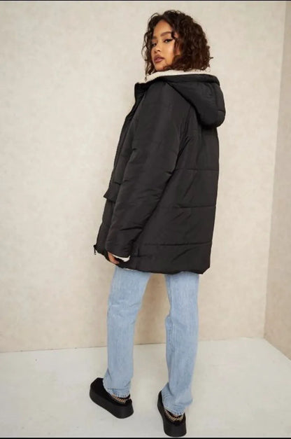 Reversible black down jacket with faux fur-lined hood