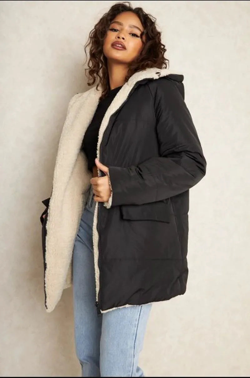 Reversible black down jacket with faux fur-lined hood