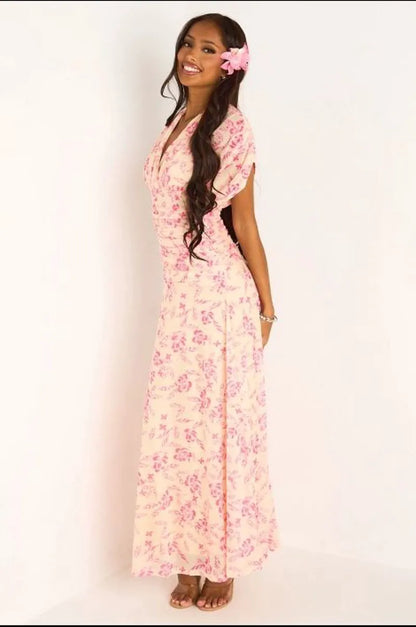 Robe jaune à motifs floraux rose et effet drapé