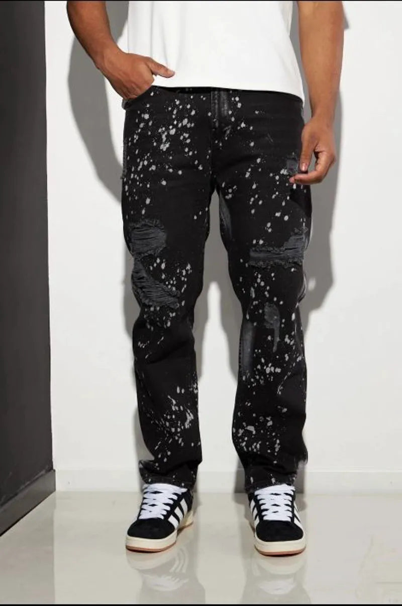 Black distressed jeans with white paint splatter.