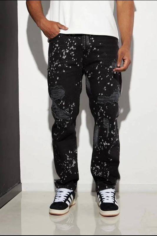 Black distressed jeans with white paint splatter.