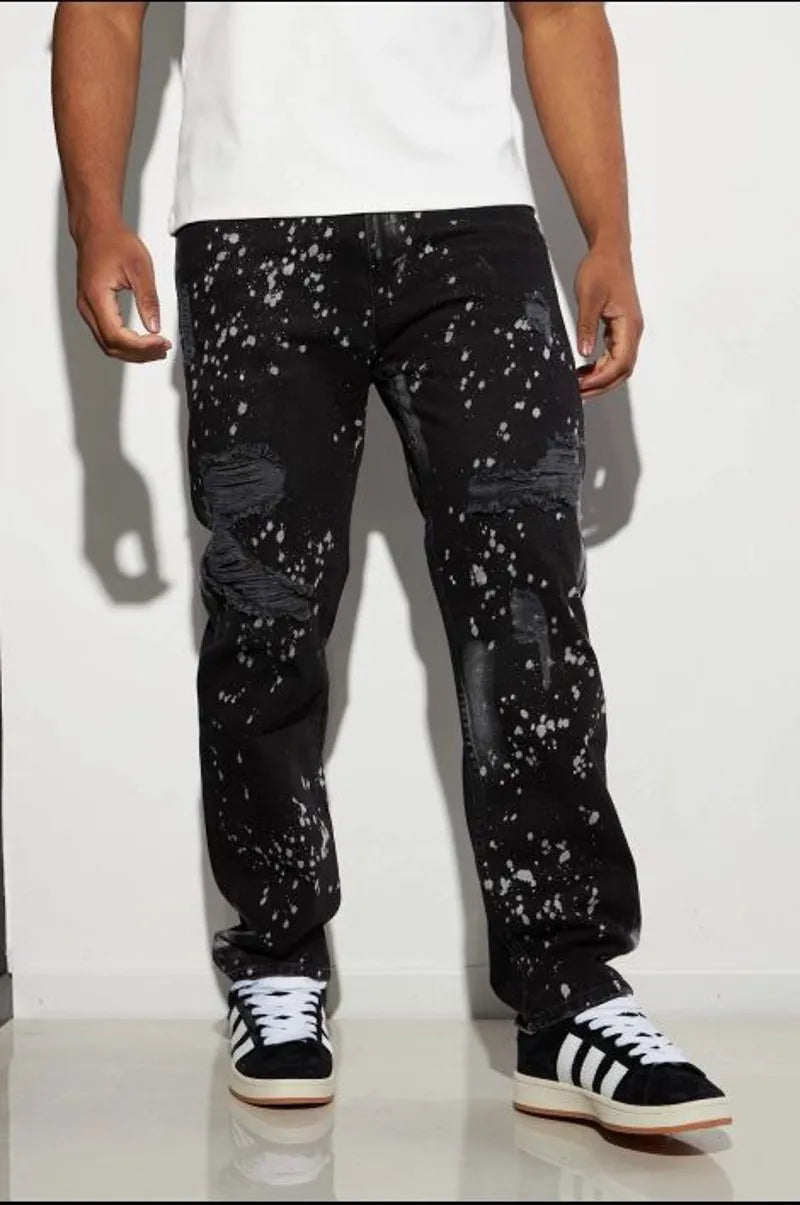 Black distressed jeans with white paint splatter.