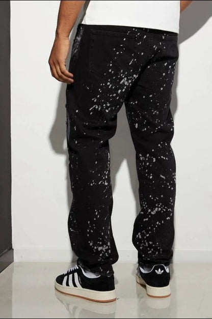 Black distressed jeans with white paint splatter.