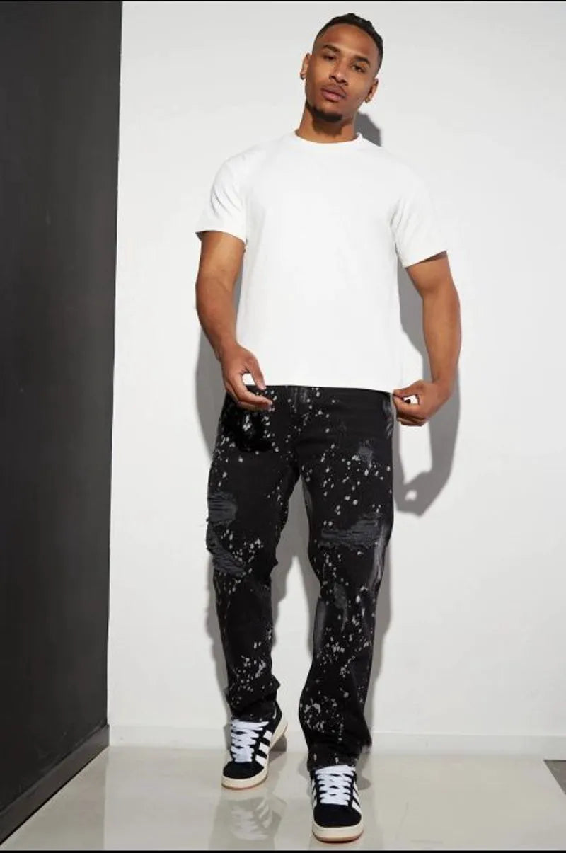 Black distressed jeans with white paint splatter.