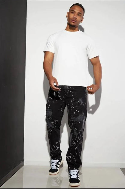 Black distressed jeans with white paint splatter.