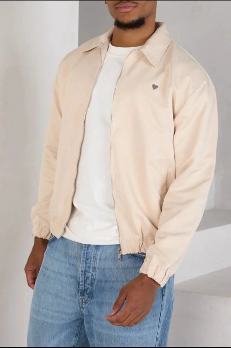 Beige zip-up jacket with a heart on the chest