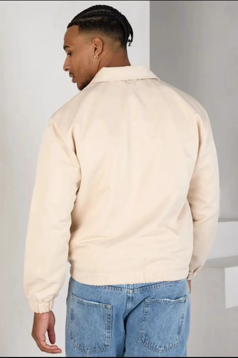 Beige zip-up jacket with a heart on the chest