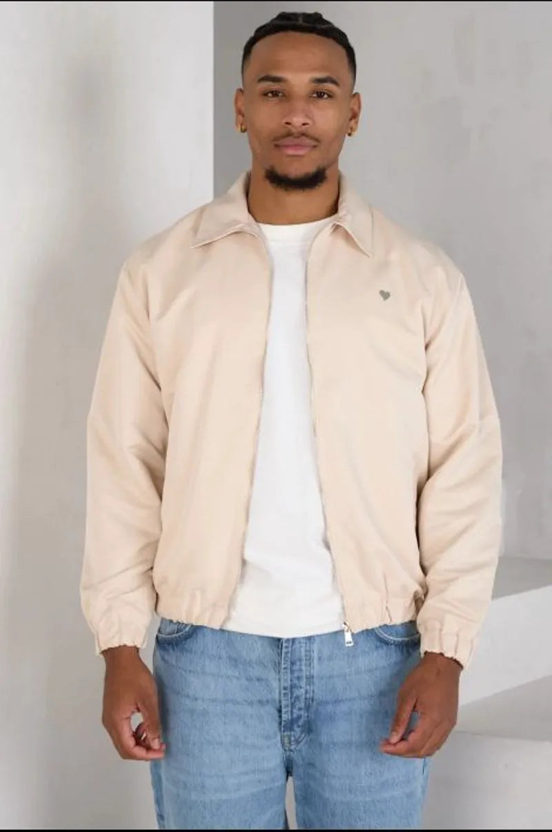 Beige zip-up jacket with a heart on the chest